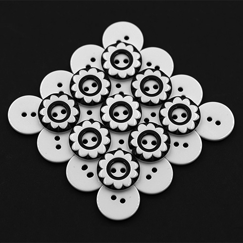 19258 Sullivans 18mm Round Plastic Button 2 Hole - Black With White Flower Impression - 55 In A Tube 