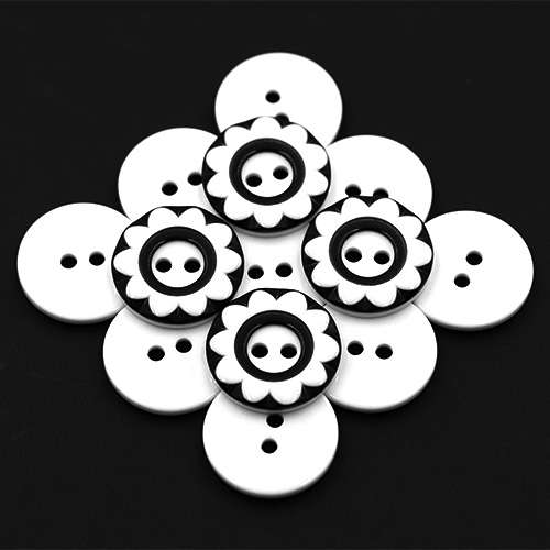 19259 Sullivans 25mm Round Plastic Button 2 Hole  - Black With White Flower Impression - 35 In A Tube 