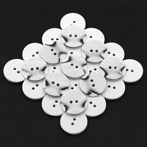 19305 Sullivans 21mm Round Plastic Button 2 Hole With 2 Textured Patterns - White With A Splash Of Black -