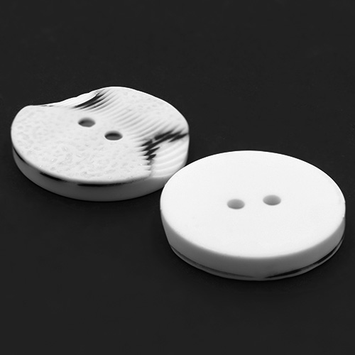 19306 Sullivans 30mm Round Plastic Button 2 Hole With 2 Textured Patterns - White With A Splash Of Black -